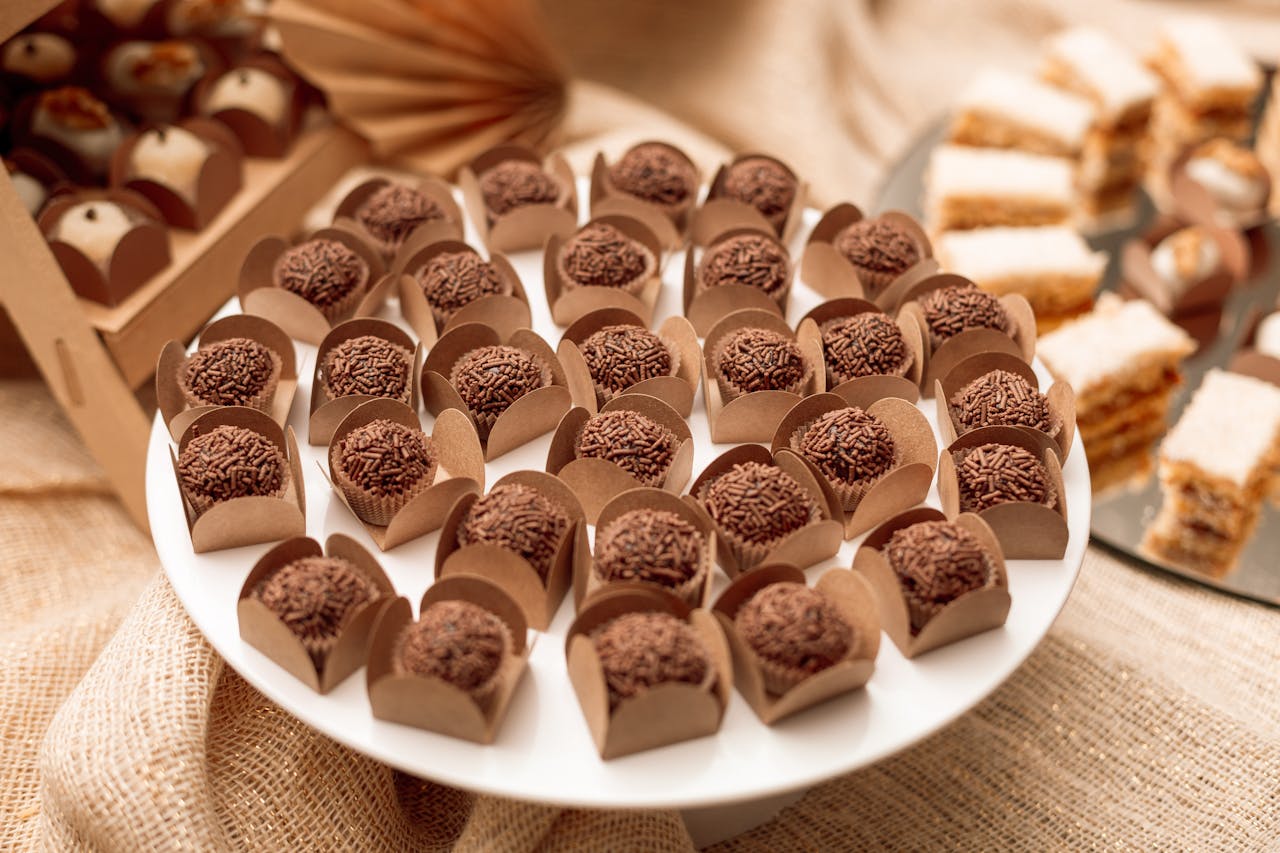 A sumptuous display of Brazilian brigadeiros on a dessert table in São Paulo, perfect for catering and events.